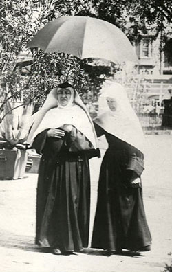 Mother Caroline Friess (at left) walking with a novice at the Milwaukee Motherhouse, circa 1891.