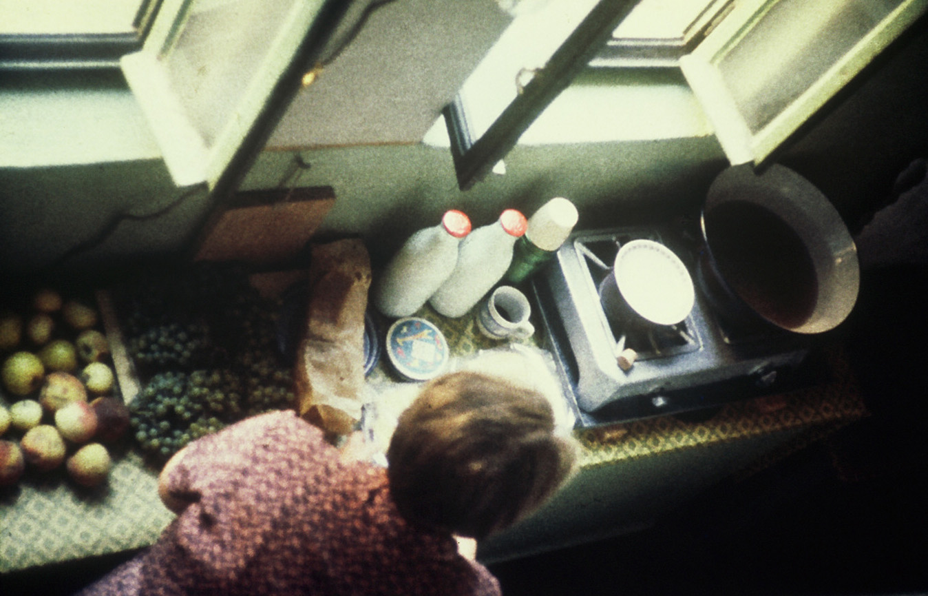 Preparing a meal on a hotplate in the stairwell.