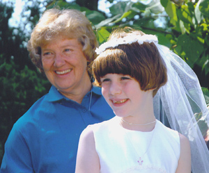 Rita Schonhoff is active in her parish and is shown with a first communicant whose parents have supported her ministry.