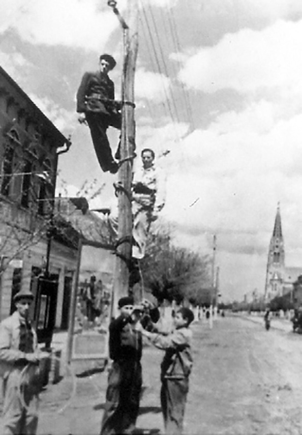 School Sister of Notre Dame (second from top) and coworkers repairing telephone lines in Romania.