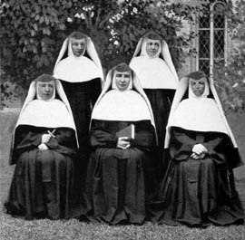 According to S. Rosella Kneice (ML) who worked in the printery in Milwaukee in the 1920's, Rev. Mother M. Stanislaus Kostka, Commissary General, didn't like the way the habits looked on the five pioneers in their original group photo. She had five sisters, Crispin Linse, Agnes Hoffman, F. DeChantal Oswald, Aluine Hoerres, and Mary Xavier Baggeler, dress in their best (1920's starched veils and folded wimples) to pose for a picture as closely matched in position as possible. Then the faces of the pioneers were cut from the real picture and superimposed on the 1920's figures. These sisters had to take an oath of secrecy. S. M. Rosella cannot identify the face put on the person in the Mother Caroline position. Was that perhaps taken from Caroline's passport, or is that another person?The pioneers were, from left to right, as follows: Front row: Mother Seraphine, Mother Caroline, Sister Emmanuel, Mistress of Novices. Back row: Mother Theophila, Sister Seraphica. (From Mother Caroline and the School Sisters of Notre Dame by Sister Dymphna Flynn, 1928).