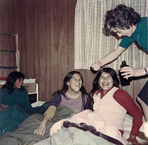 Sister Janet Disbrowe giving Victoria cough medicine at sleep-over. Aroland, 1975.